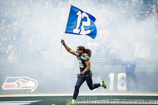 Seattle Seahawk Sidney Rice runs onto the field with the 12th man flag